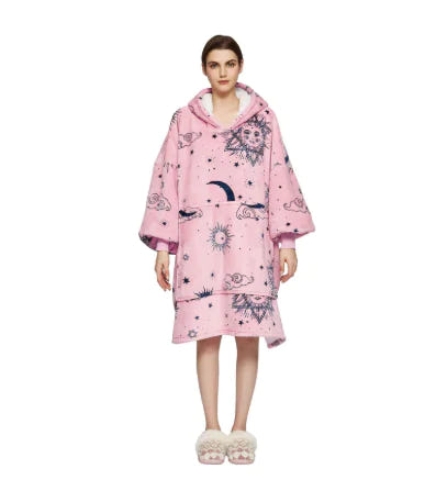 Person wearing a pink hooded garment with celestial pattern on a white background