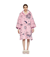 Person wearing a pink hooded garment with celestial pattern on a white background